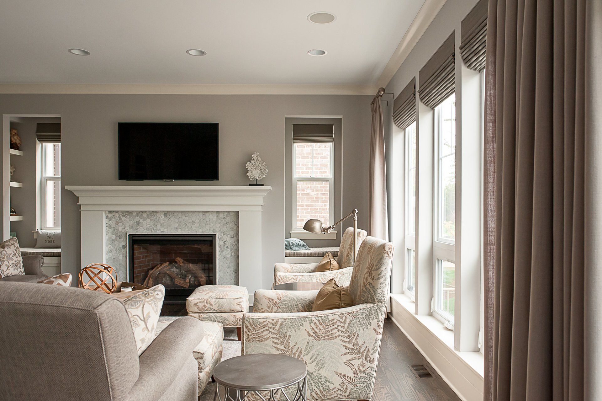 A living room with a fireplace and a flat screen tv