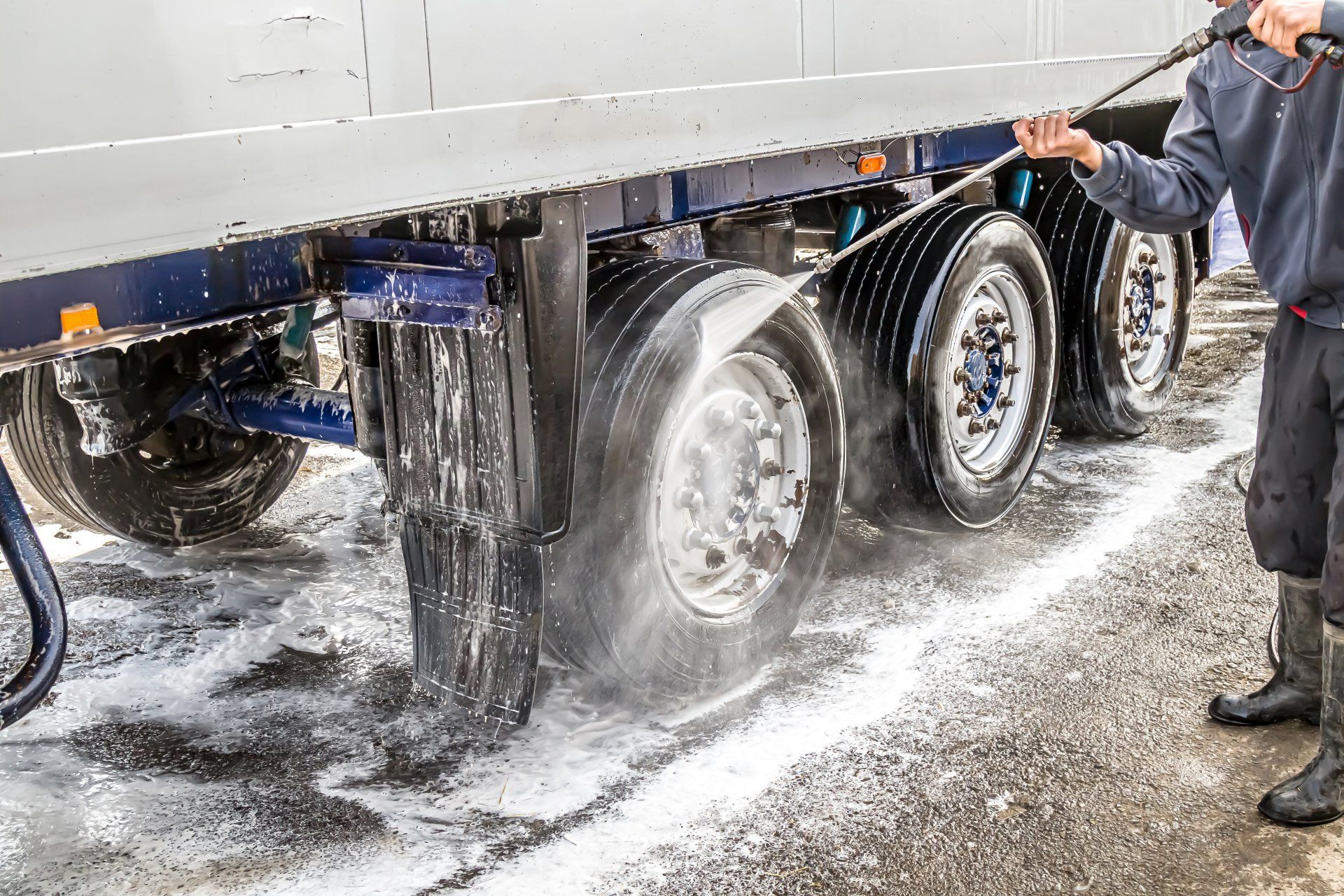 Truck being washed with soap during a thorough car wash.