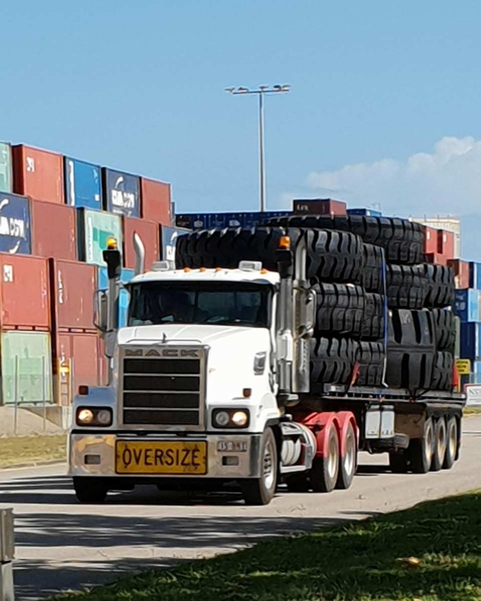 oversize transportation truck with tires on back