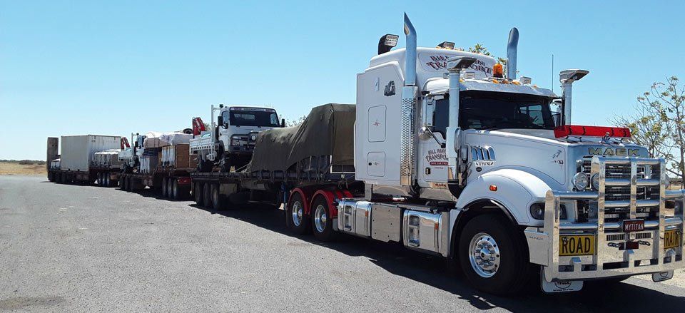 truck transporting machinery and supplies