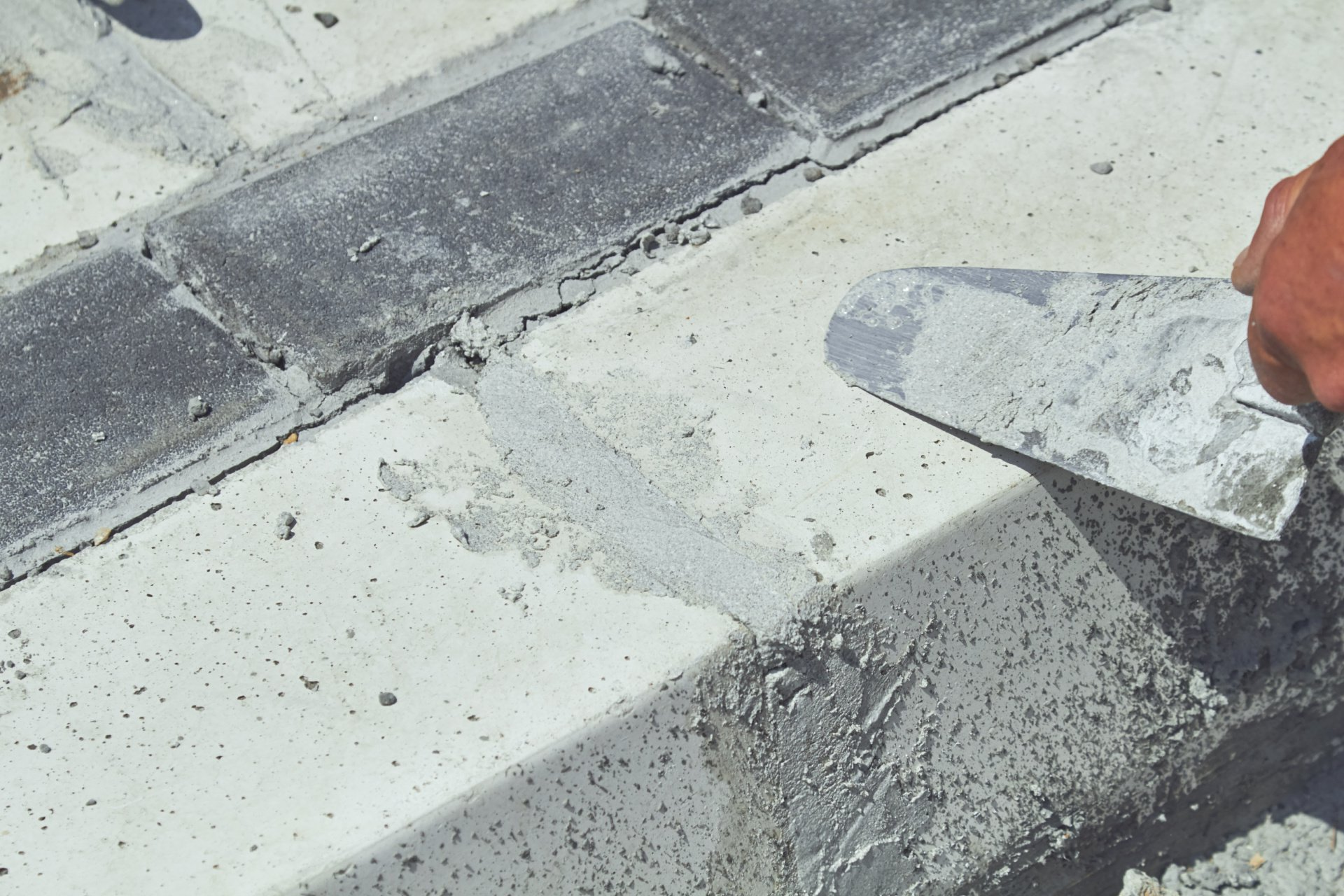 A cracked piece of concrete that is being repaired by the professionals at San Antonio Paving Solutions