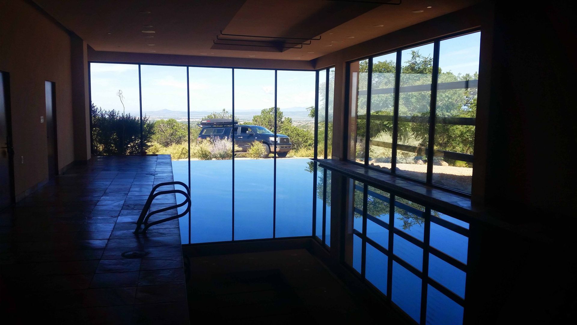 A large indoor swimming pool with a lot of windows