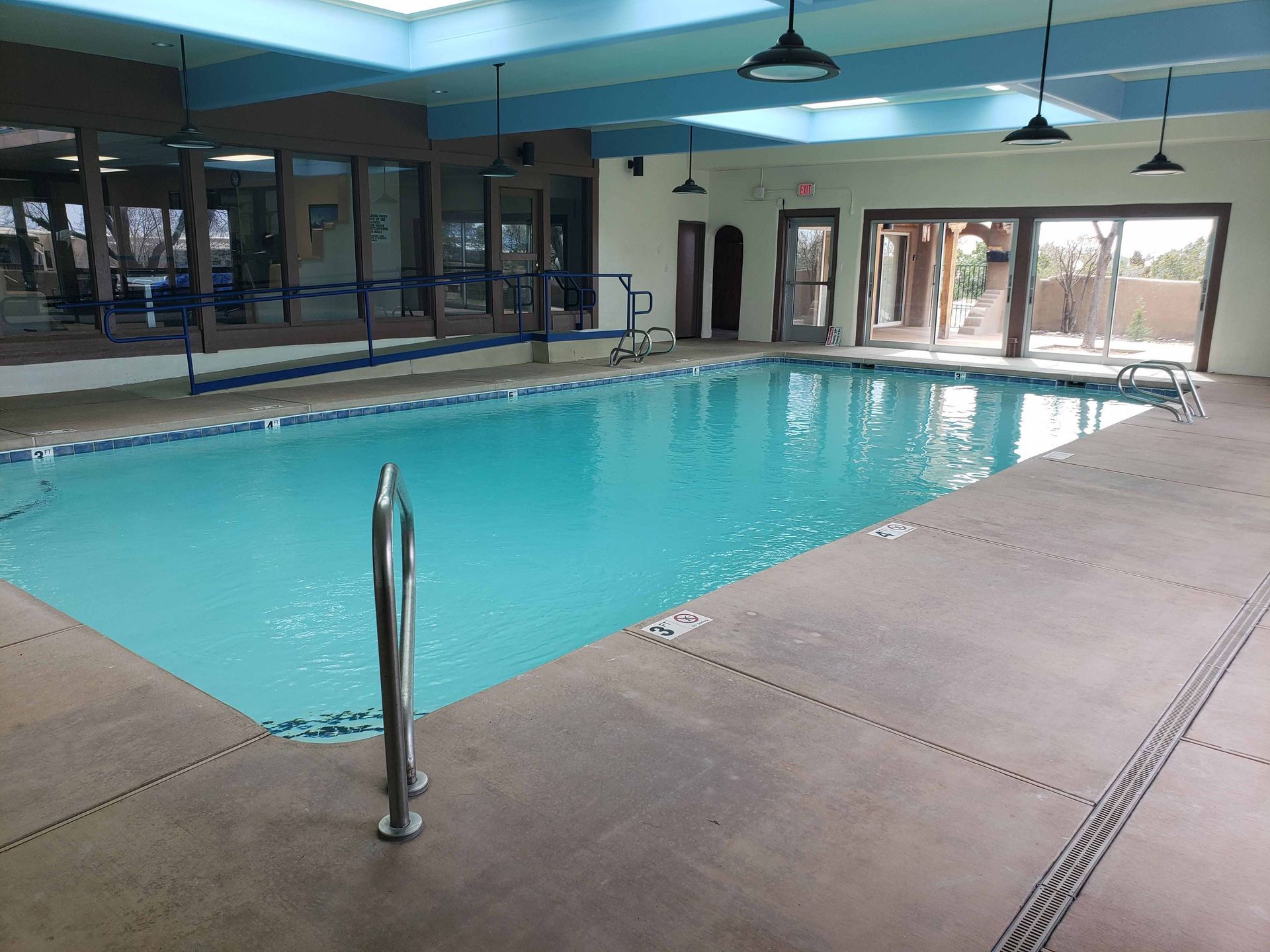 A large indoor swimming pool with a staircase leading to it