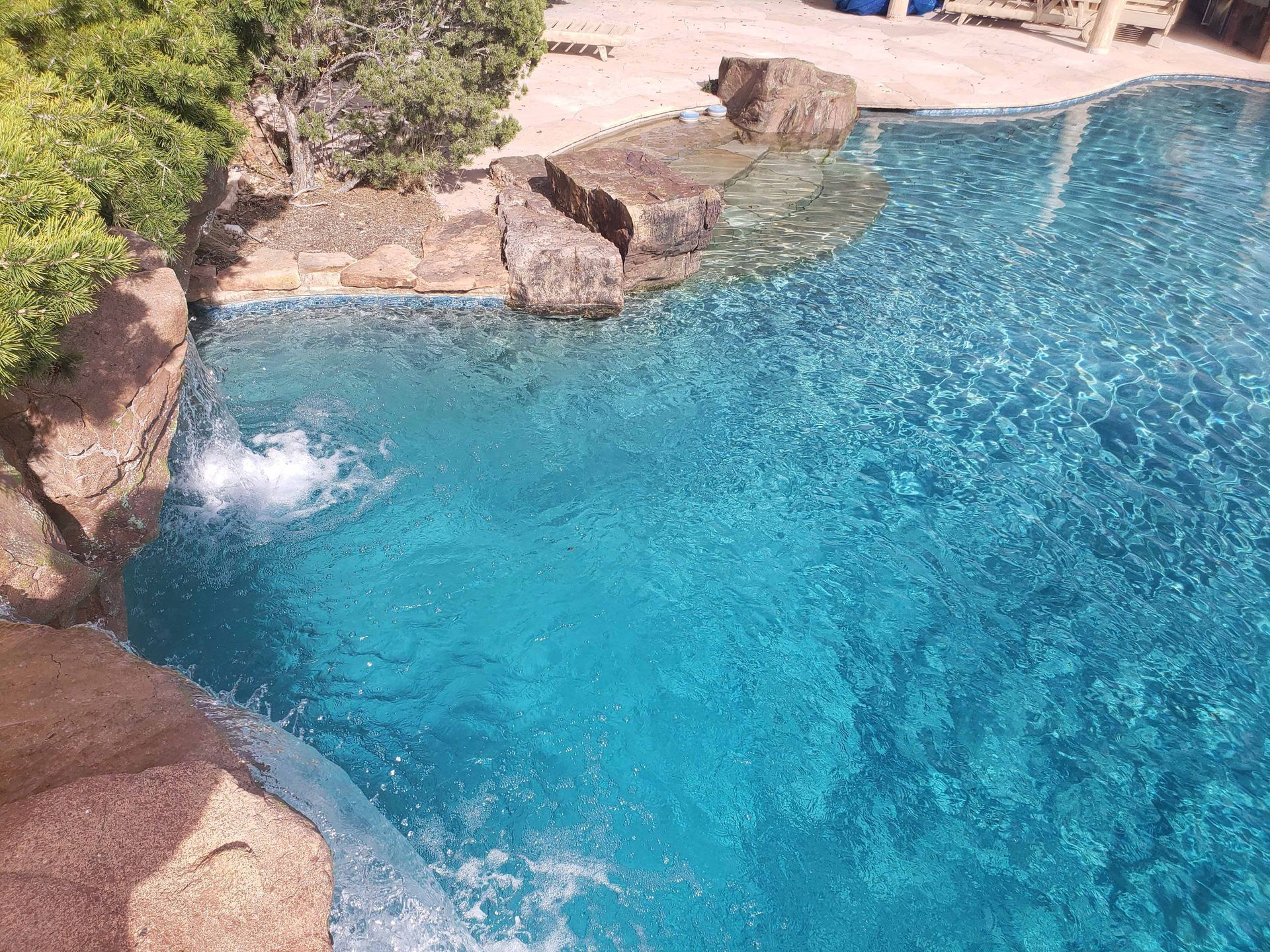There is a waterfall in the middle of the pool