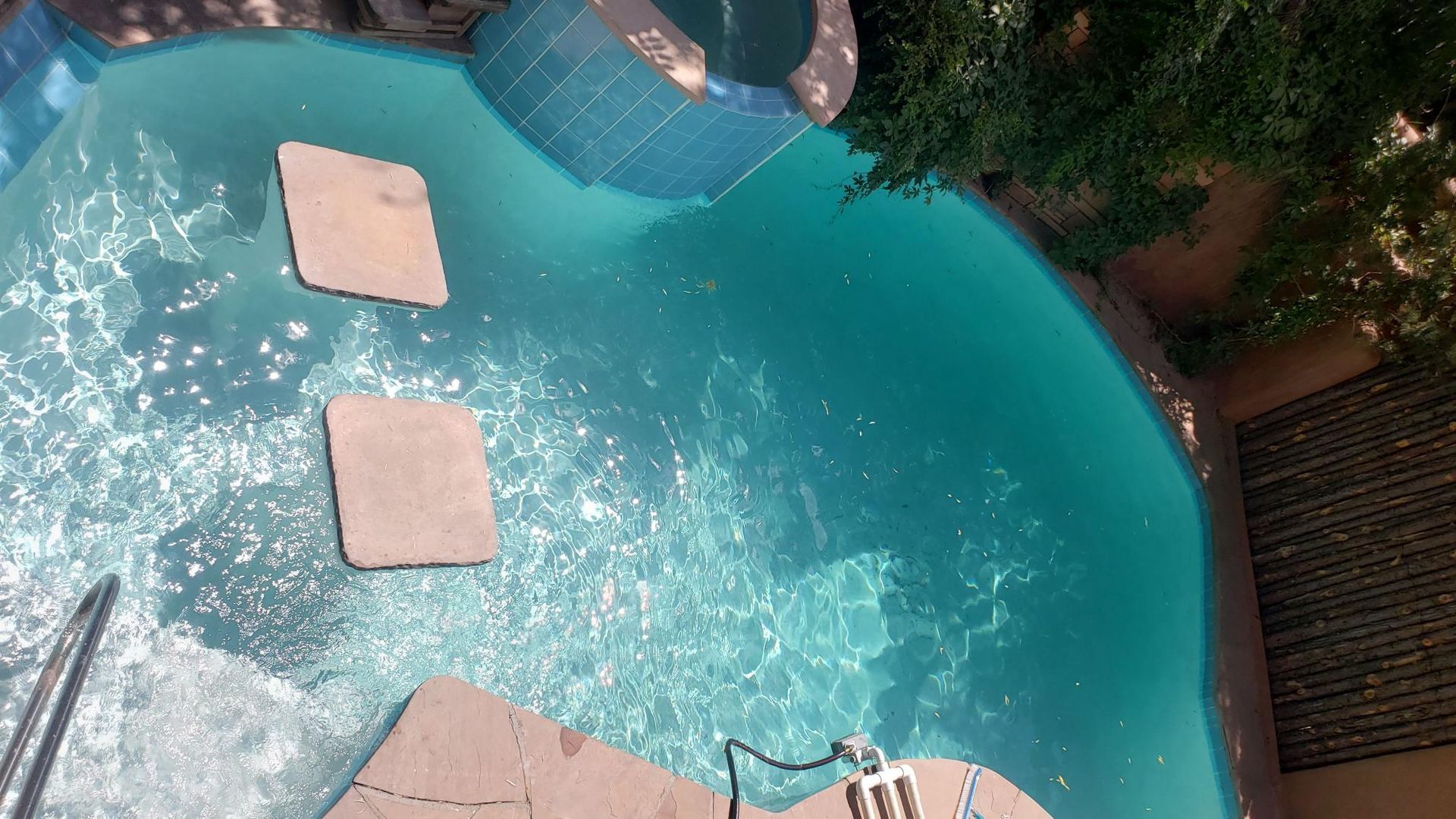 An Aerial View of a Large Swimming Pool With Steps Leading to It