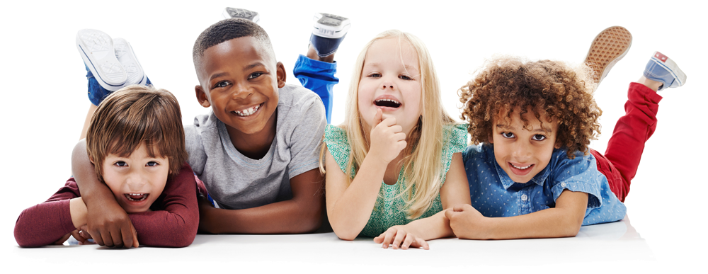 A group of children are laying on the floor together and smiling.