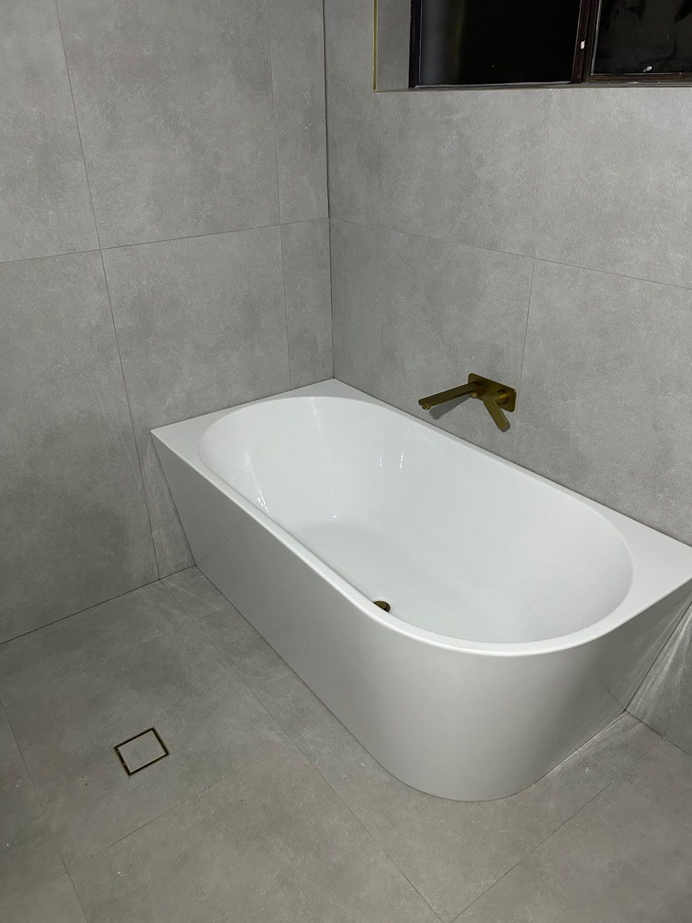 Clean And Empty Side Left Bathtub With Tap Above — Kitchen, Laundry & Bathroom Renovations in Mittagong, NSW