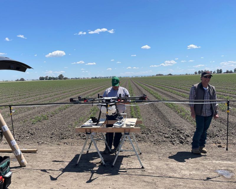 Rantizo preparing drone for foliar applications on tomato crops in California farm field