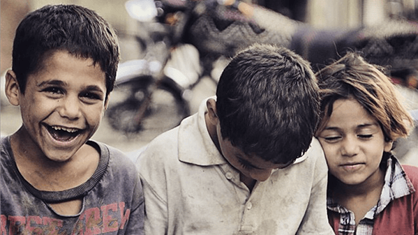 Refugee children play on a street