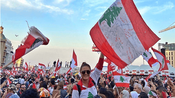 Photo of Lebanese citizens during protest holding the Lebanese flag