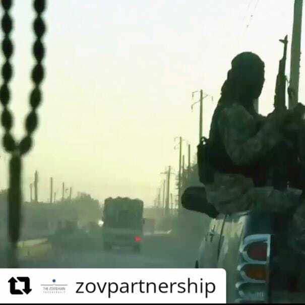 Photo of a Yazidi man standing in an empty and destroyed town