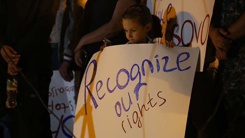Young girl holding a poster calling for the recognition of Armenian rights