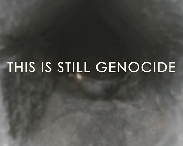 This is Genocide writing on a grey background, screenshot from the Yazidi-led documentary