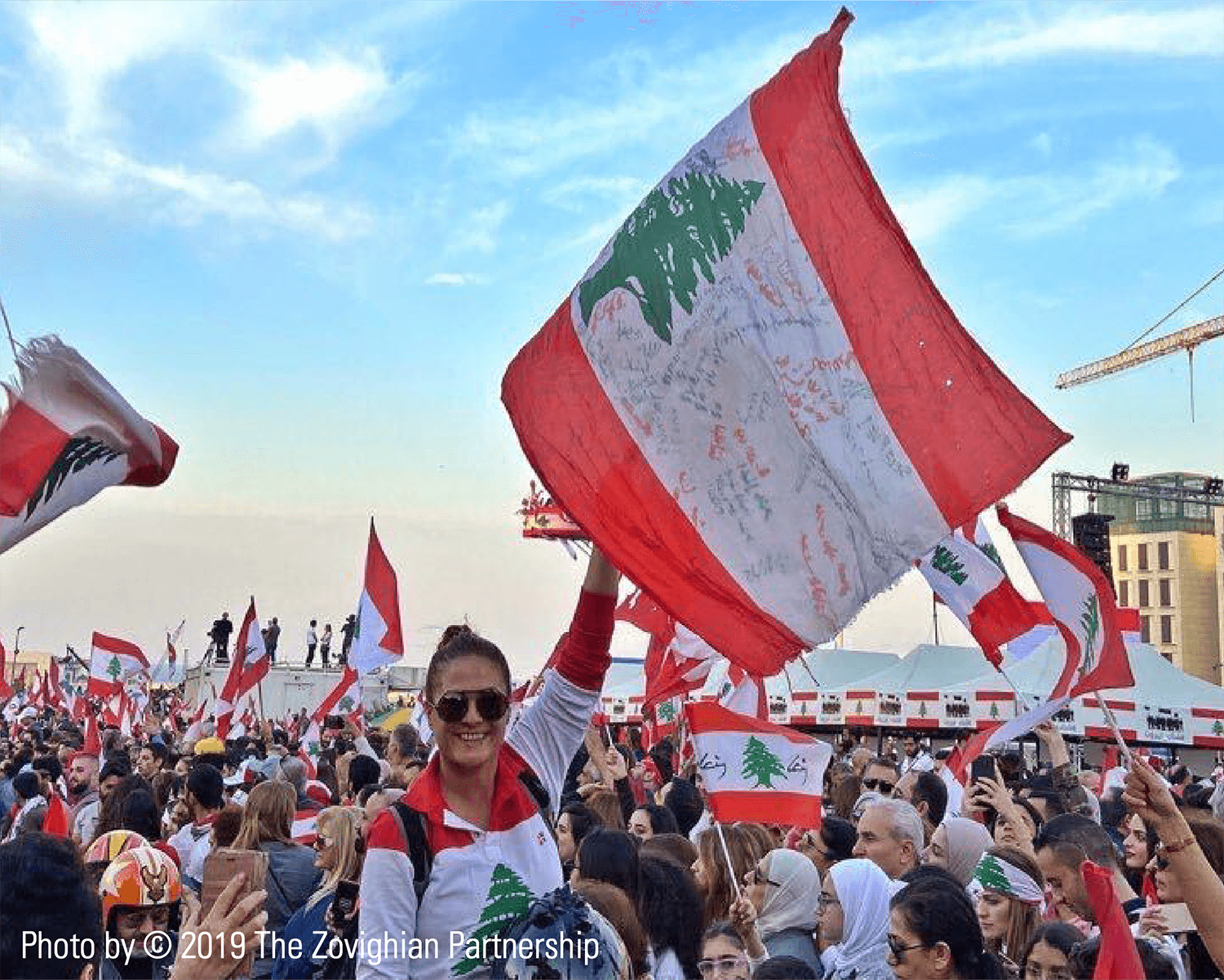 Lebanese woman carrying the Lebanese flag during Beirut protests