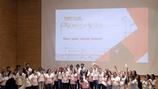 Group photo of participants of TEDx talk on stage