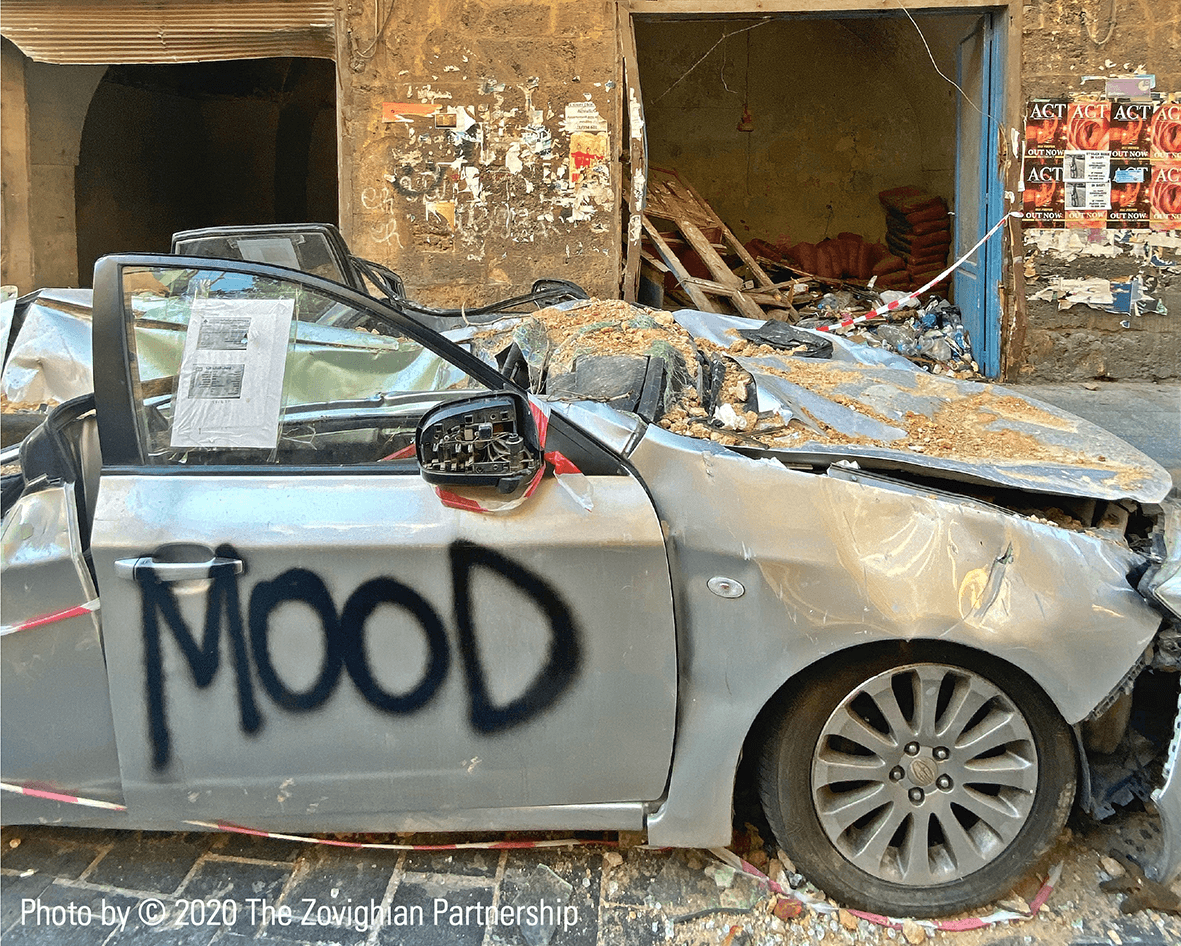Wrecked car and a damaged building following the Beirut explosion