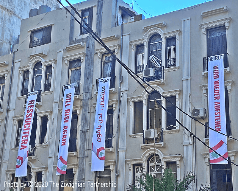 Banners hang on a building expressing that Lebanon will rise again before the visit of French President Emmanuel Macron