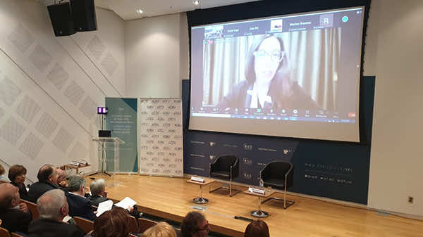 Lynn Zovighian on the projector screen remotely, at the AUB IFI auditorium, remotely moderating conference