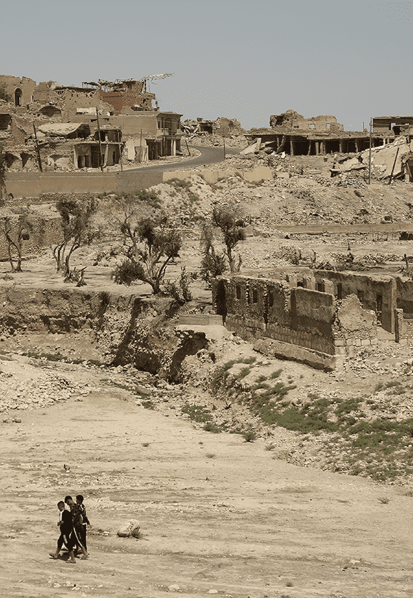People walking in the destroyed region of Sinjar