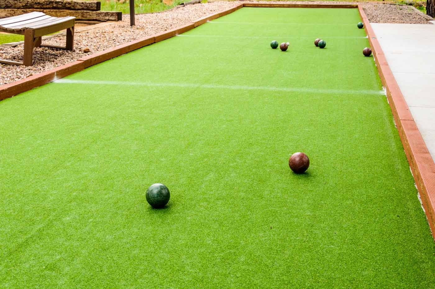 A group of golf balls are sitting on top of a green field.