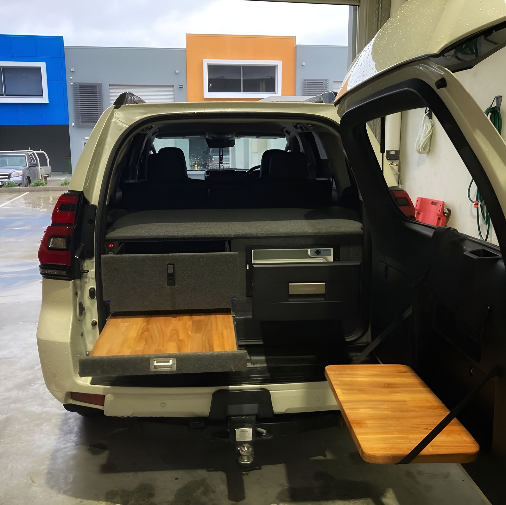 A White SUV With A Wooden Table In The Back — Live Unbound Campers In Tweed Heads, NSW