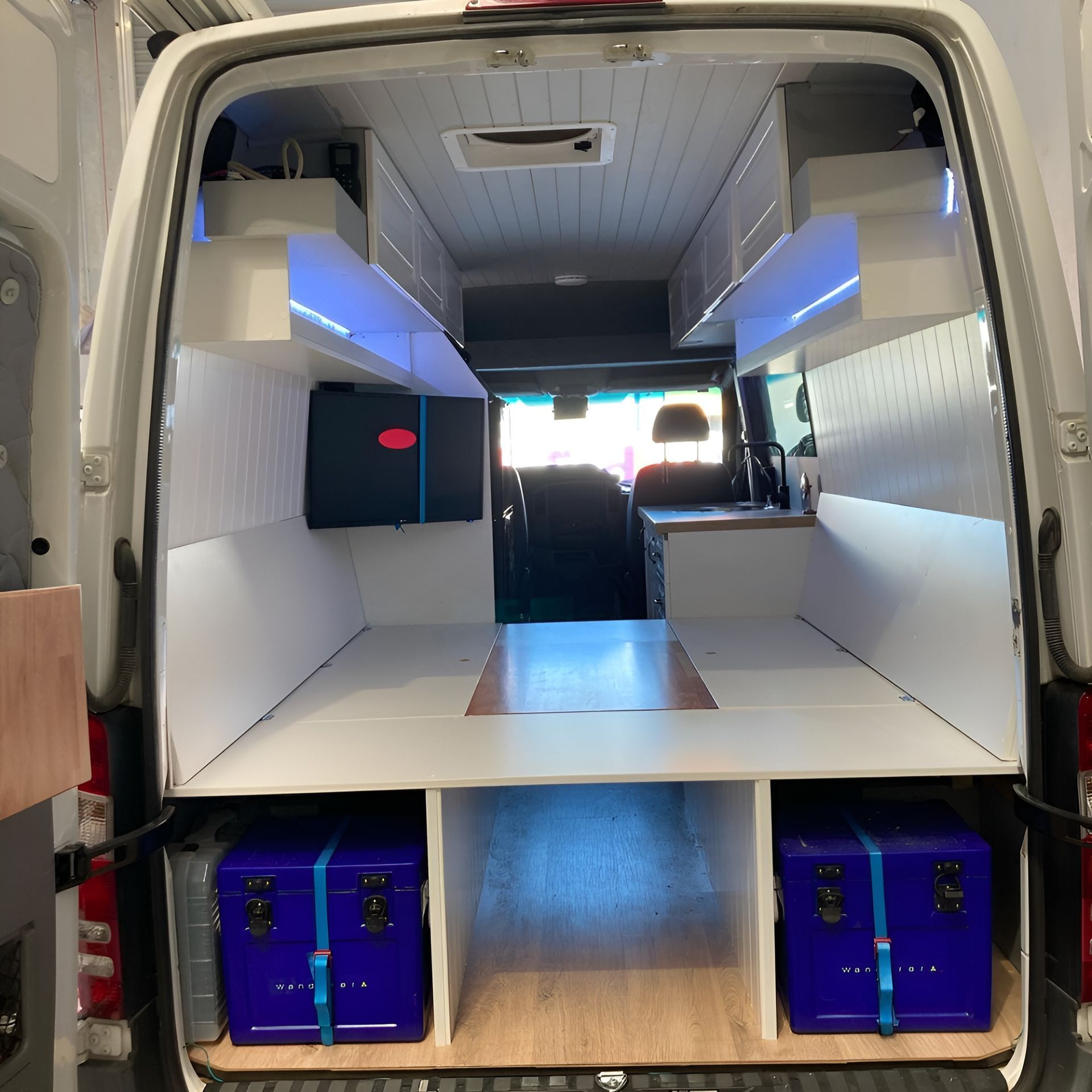 The Inside Of A Van With A Bed And Shelves — Live Unbound Campers In Upper Coomera, QLD