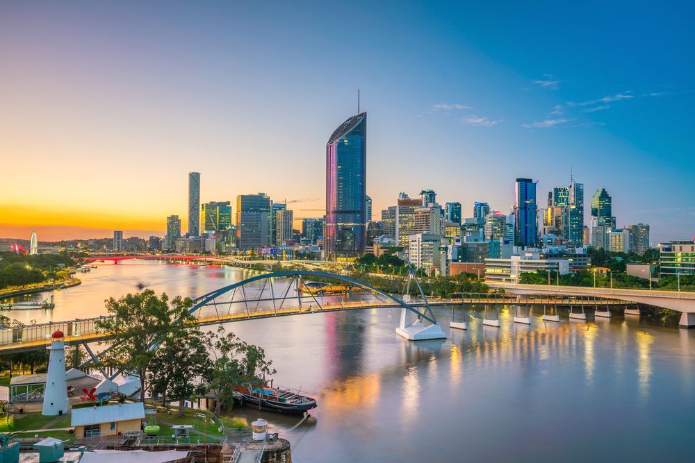 An Aerial View Of A Brisbane Skyline Over A River At Sunset — Live Unbound Campers In Brisbane, QLD