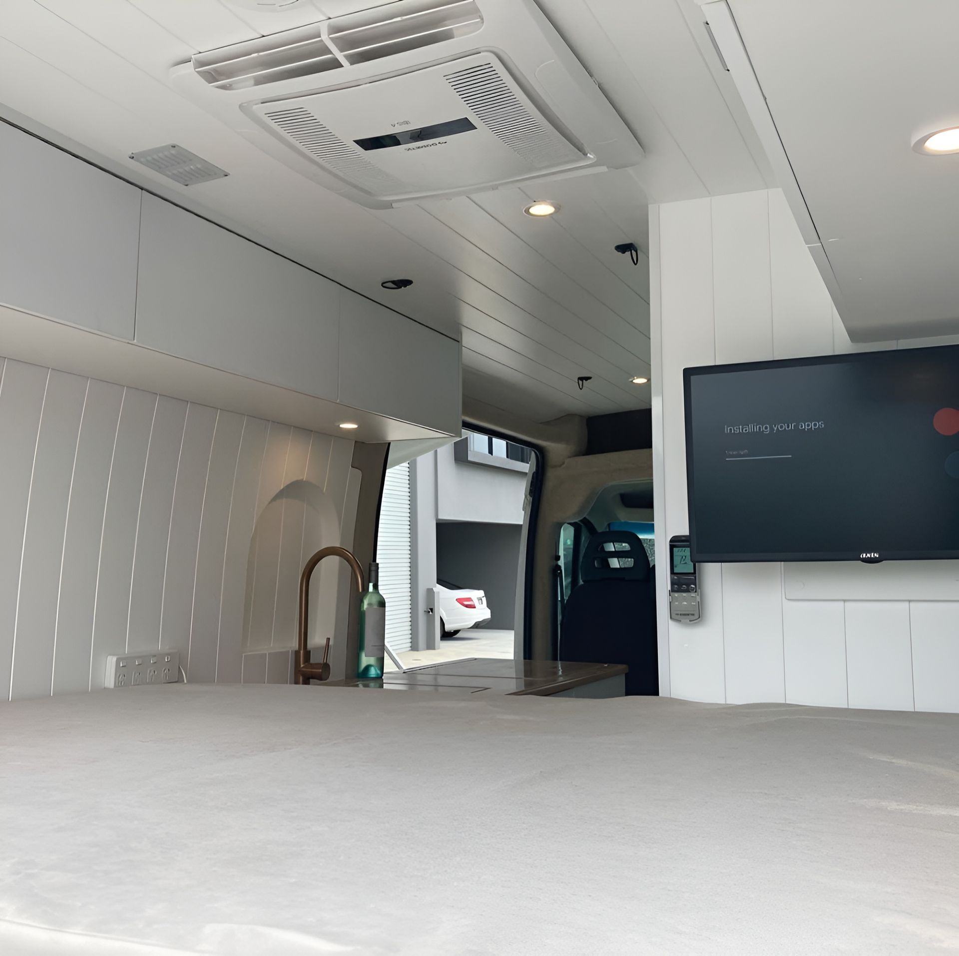 A Large Flat Screen TV Is Mounted On A Wall In A Room — Live Unbound Campers In Upper Coomera, QLD