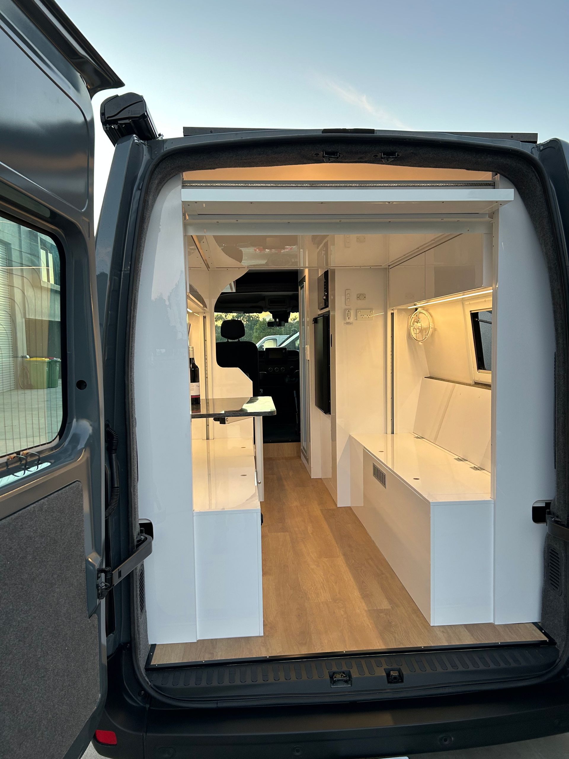 A Van With A Sink In The Back Is Parked In A Parking Lot — Live Unbound Campers In Upper Coomera, QLD