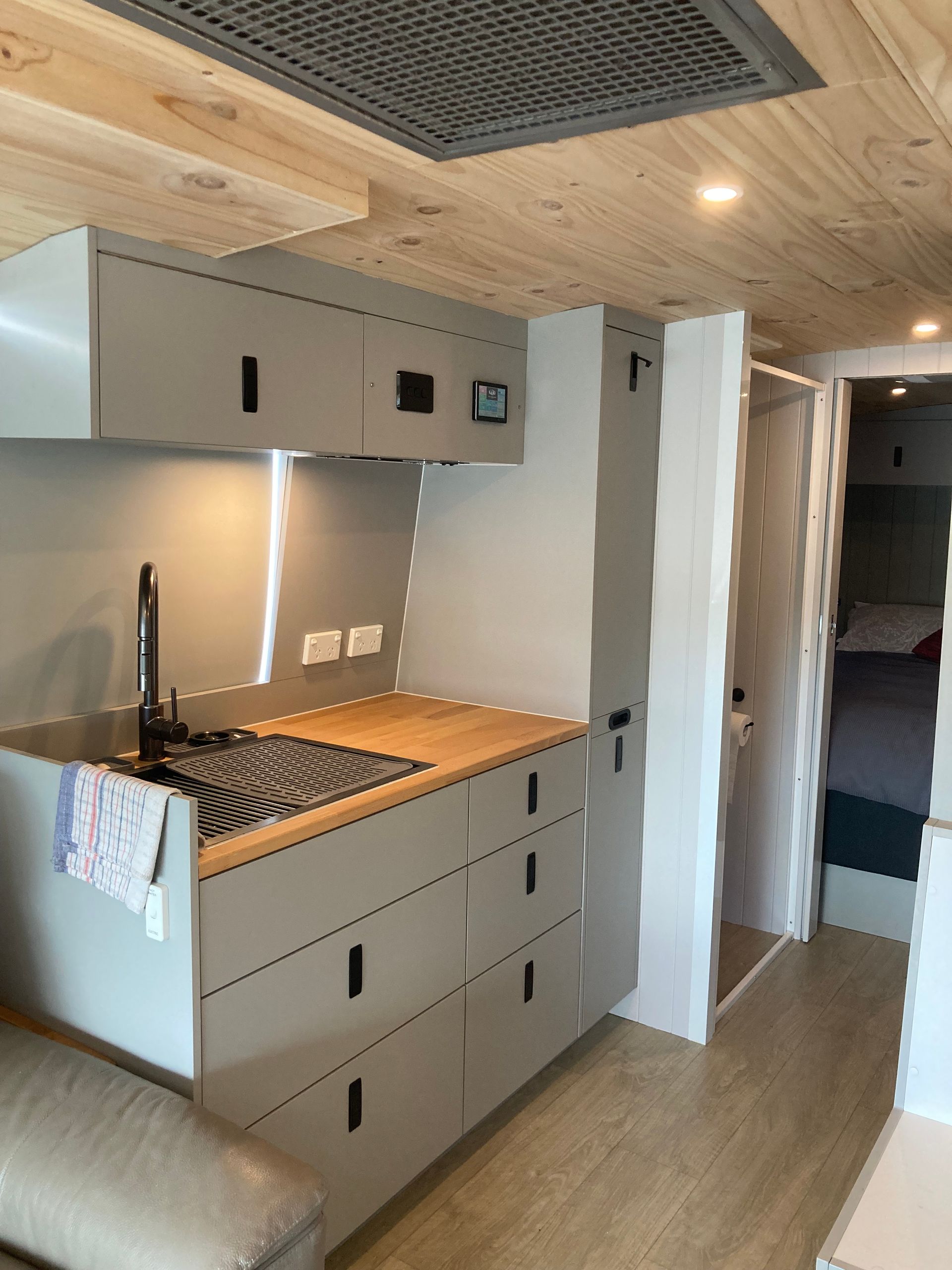 A White Van Is Parked Next To A Wooden Table — Live Unbound Campers In Upper Coomera, QLD