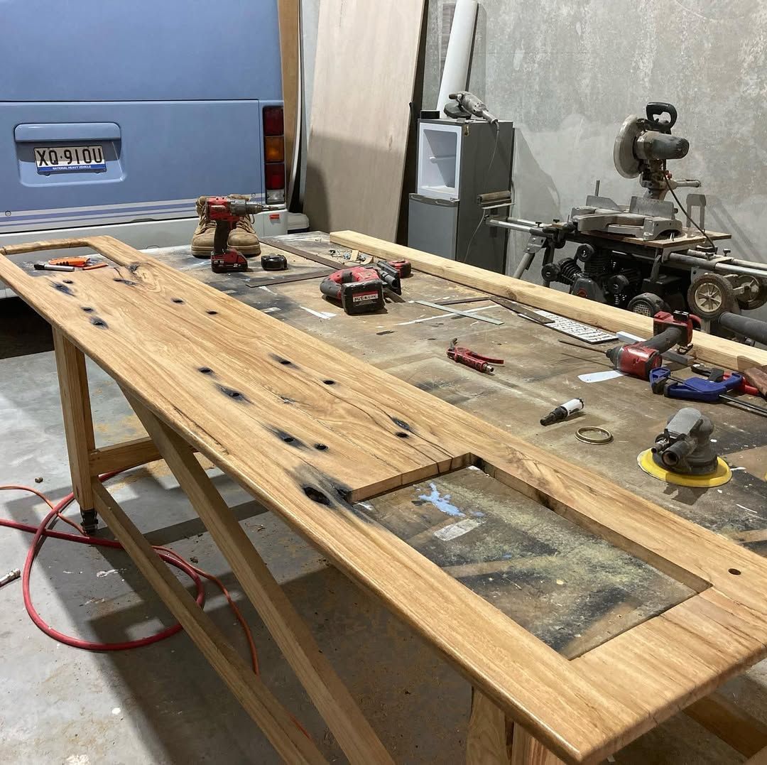 A Wooden Table With Tools On It In A Garage — Live Unbound Campers In Gold Coast, QLD