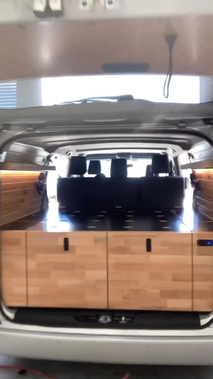 The Back Of A Van With Wooden Cabinets In It — Live Unbound Campers In Upper Coomera, QLD