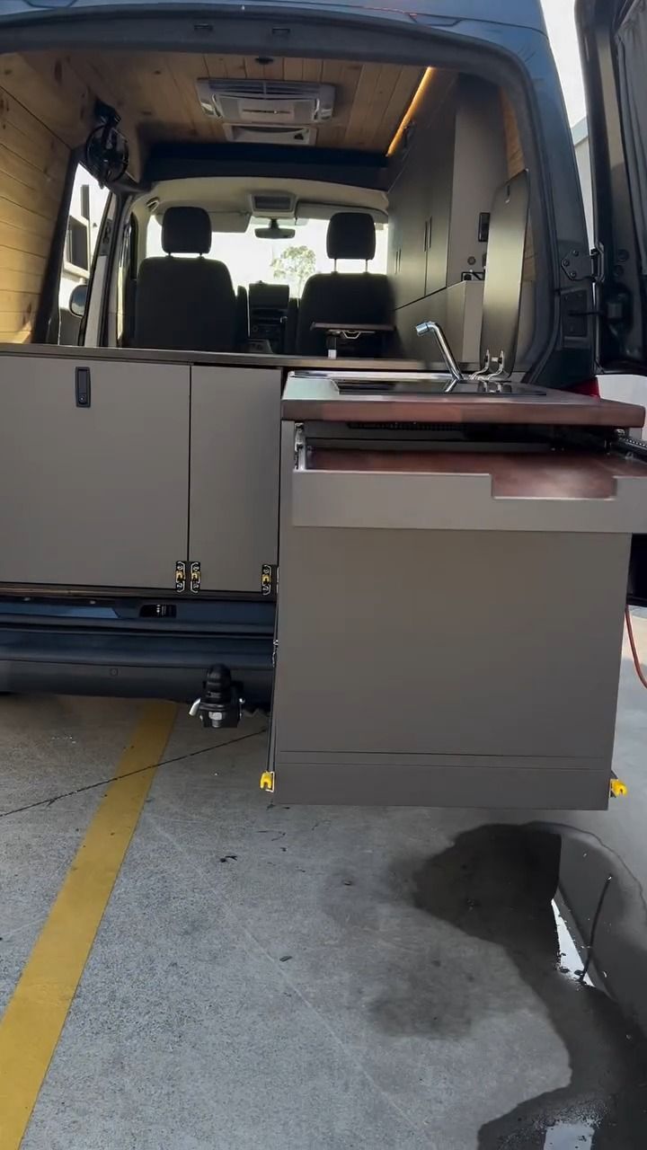 A Van With A Sink In The Back Is Parked In A Parking Lot — Live Unbound Campers In Upper Coomera, QLD