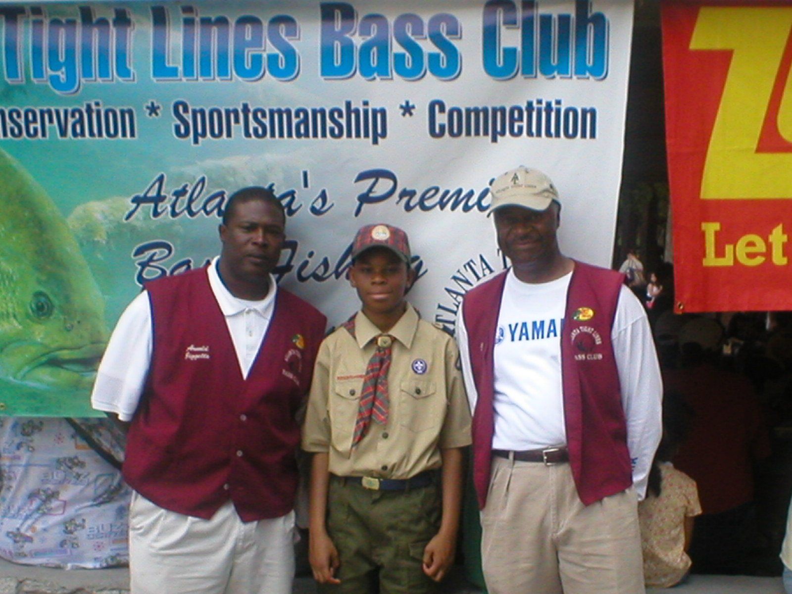 Three men pose for a photo in front of a