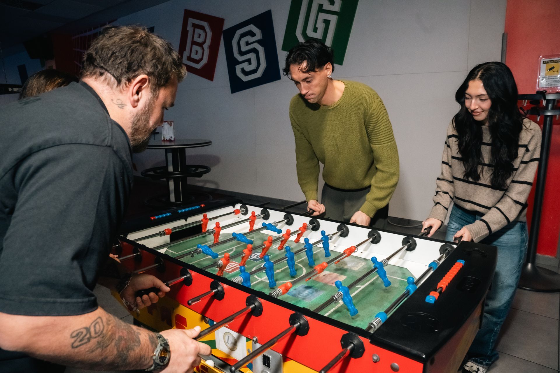 Mano che inserisce una scheda di gioco con icone in un lettore luminoso.