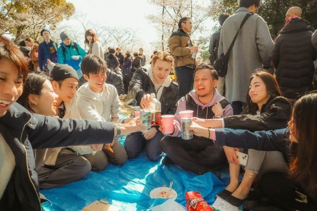 A group of people are having a picnic in a park.