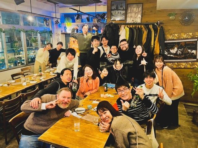 A group of people are posing for a picture in a restaurant.