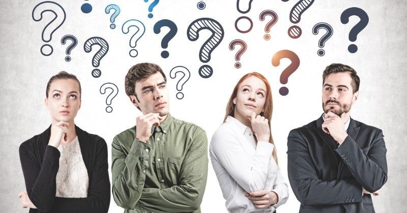 Four people in thoughtful poses with large question marks above them, suggesting confusion or uncertainty.