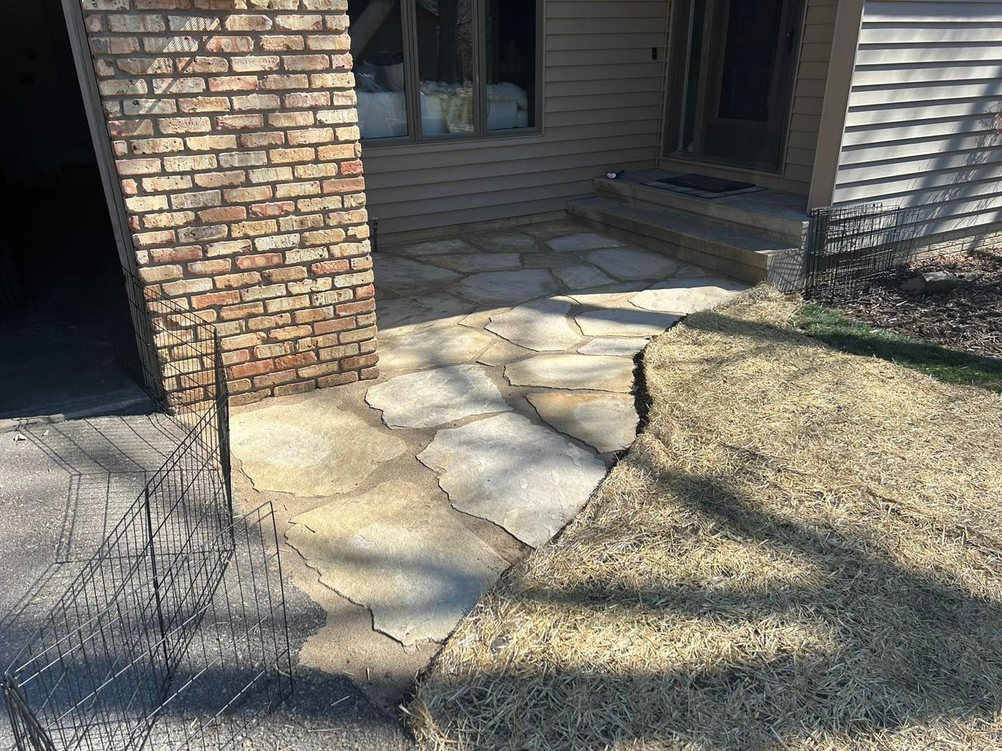A stone walkway leading to the front door of a house.