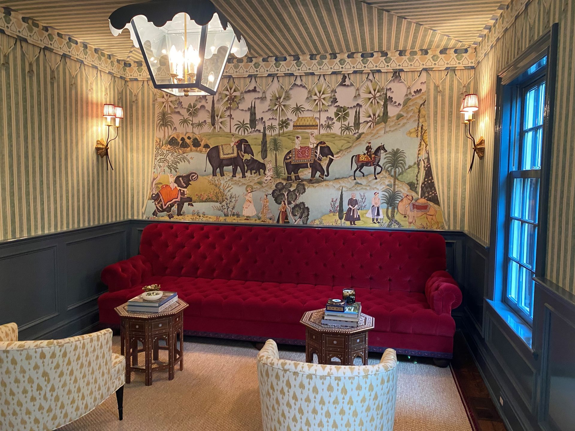 An empty room with a wooden ladder and a window.