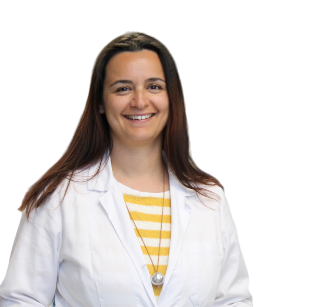 a smiling woman wearing a white lab coat and striped shirt