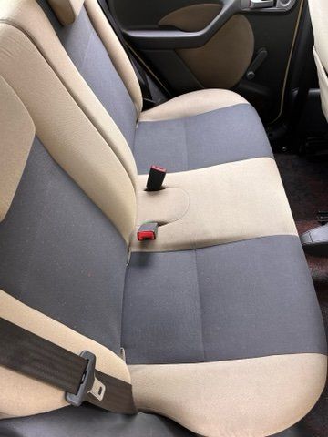 The back seat of a car with a seat belt on it