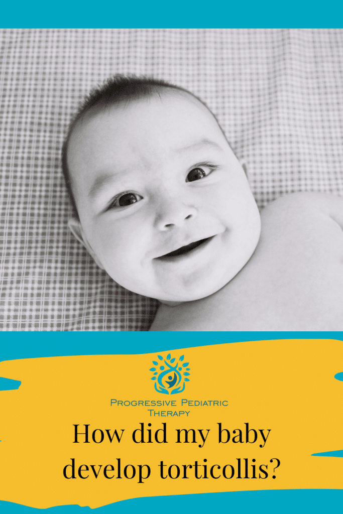A baby is laying on a bed and smiling.