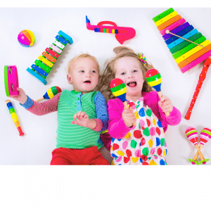 Two children are laying on the floor playing with musical instruments.