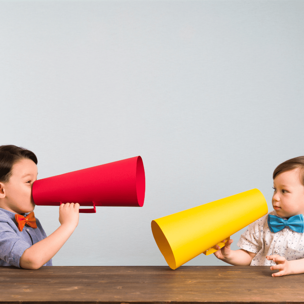 Two children are talking through megaphones at each other