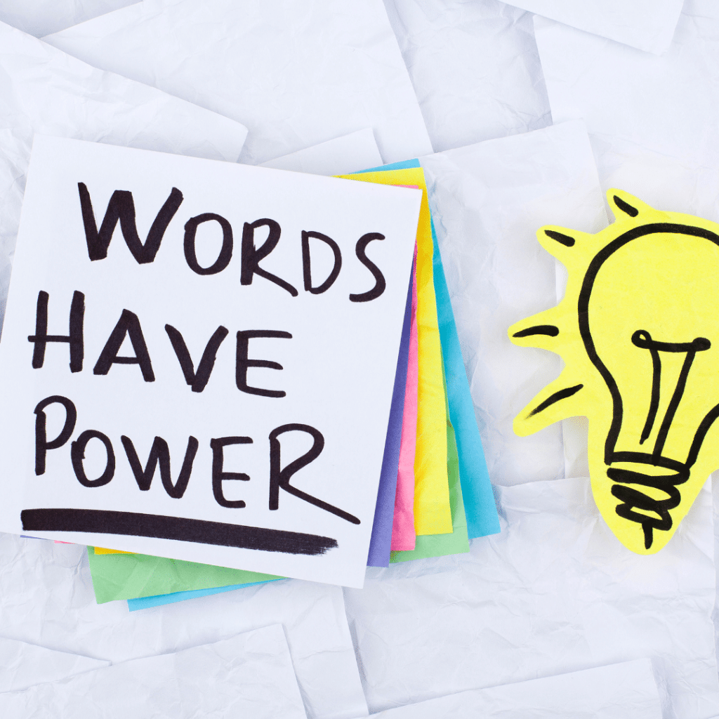 A sign that says words have power next to a light bulb