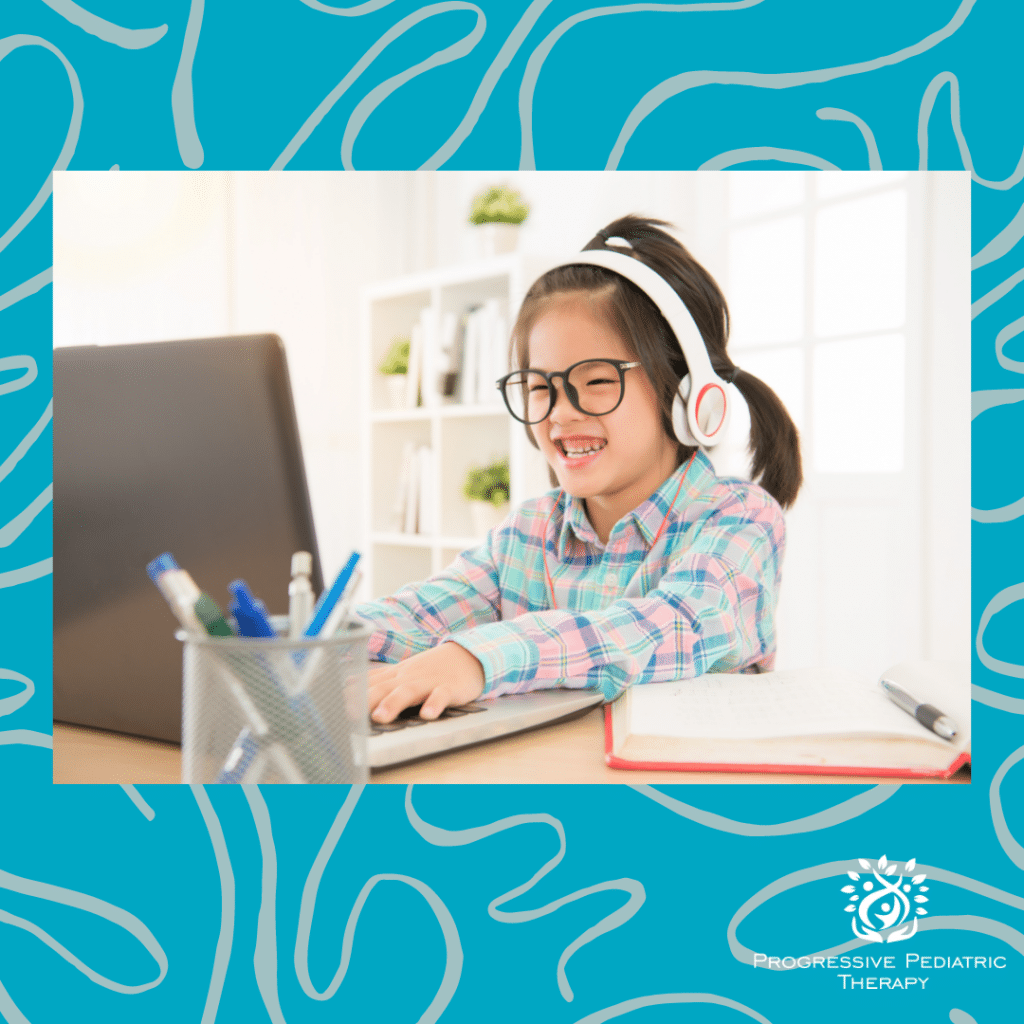 A little girl wearing headphones is using a laptop computer.