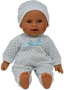 A baby doll is wearing a blue polka dot outfit and a white hat.