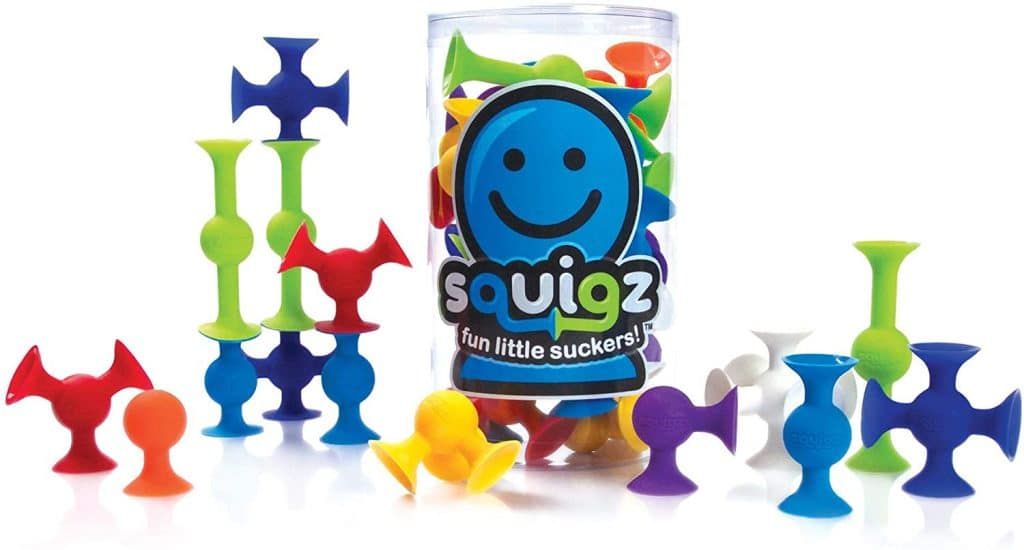 A container of squigz toys with a smiley face on it.