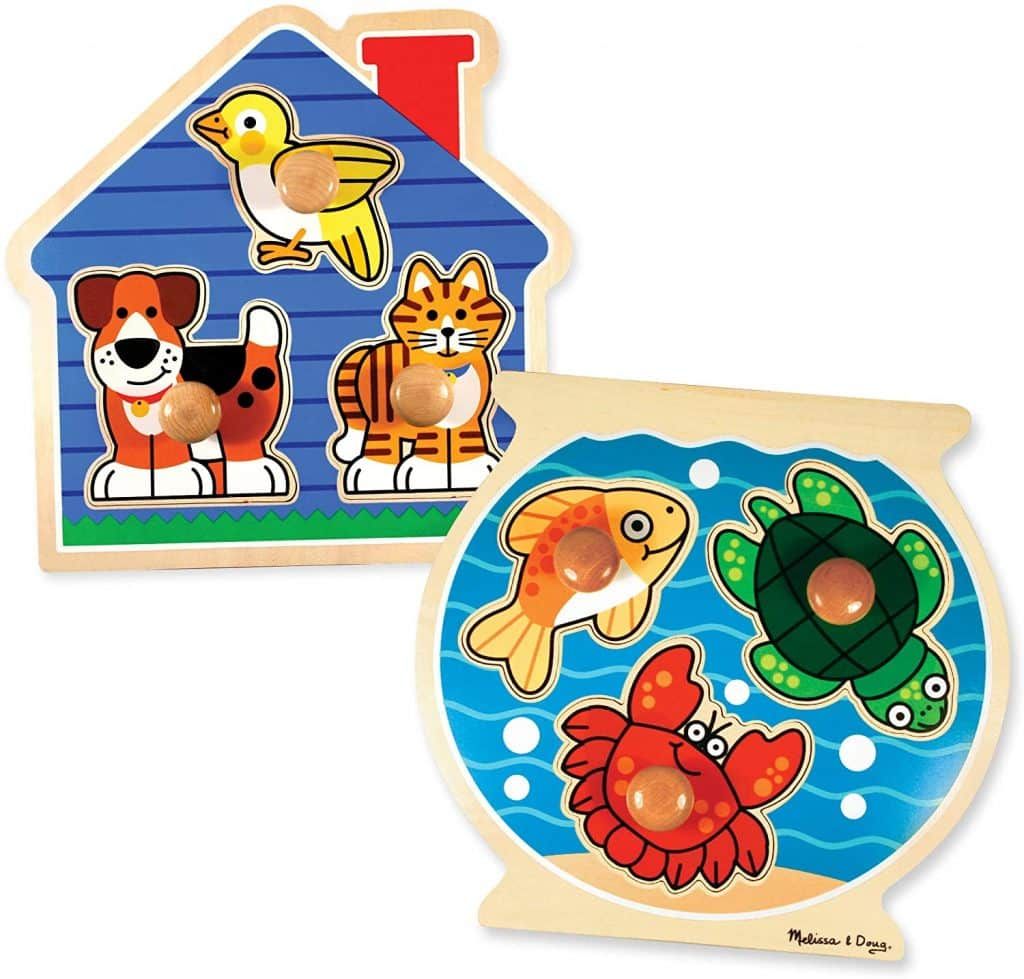 A wooden puzzle with a dog a cat and a fish on it